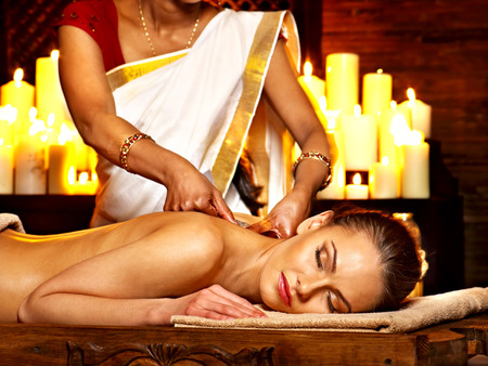 Young woman having oil Ayurveda spa treatment.の写真素材