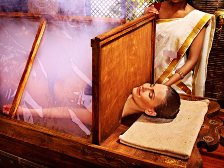 Woman having Ayurvedic sauna treatment.の写真素材