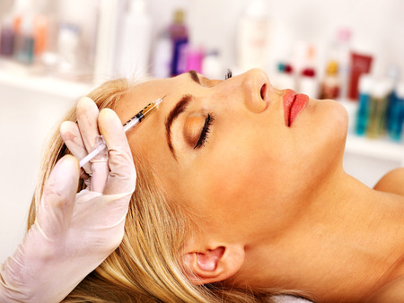 Beauty woman giving botox injections.の写真素材