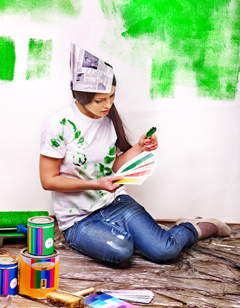 Happy woman paint wall at home.の写真素材