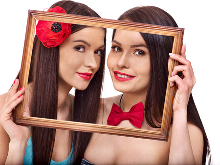 Two sexy lesbian women kissing in art frame. Isolated.