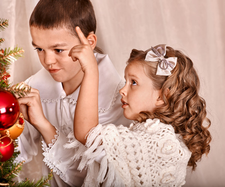 Happy child decorate on Christmas tree.の写真素材