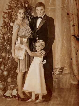 Happy family with children  dressing Christmas tree.の写真素材