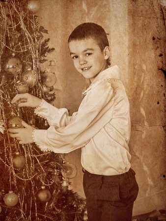 Happy child decorate on Christmas tree.の写真素材