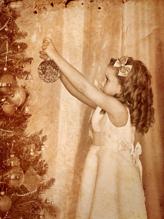 Little girl decorate on Christmas tree.の写真素材