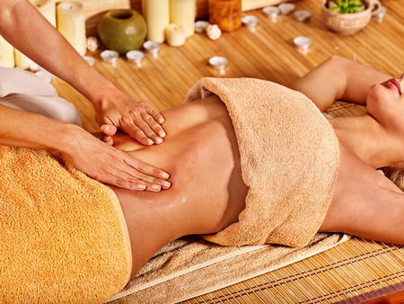 Young woman getting massage in bamboo spa.の写真素材