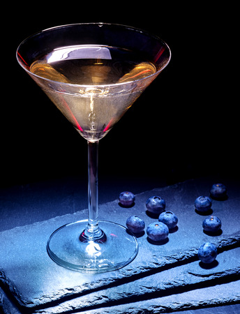 Blueberry gold drink on black background. Cocktail card 20の写真素材