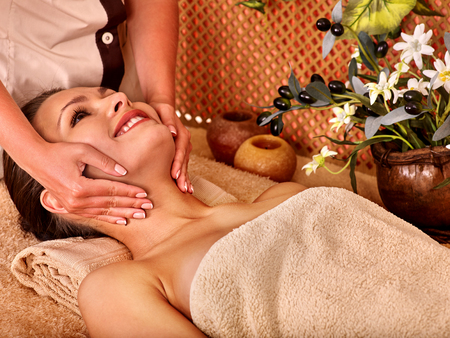 Woman getting head massage in tropical beauty spa. A lot of flower.の写真素材