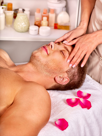 Man getting facial  massage in beauty spa.の写真素材