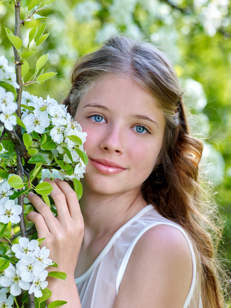Beautiful girl with flowering tree. Romantic style.の写真素材