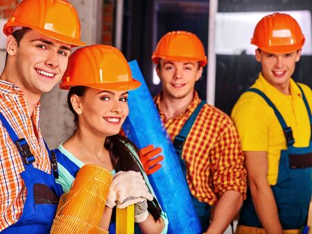 Happy group people in builder uniform. Four people.の写真素材