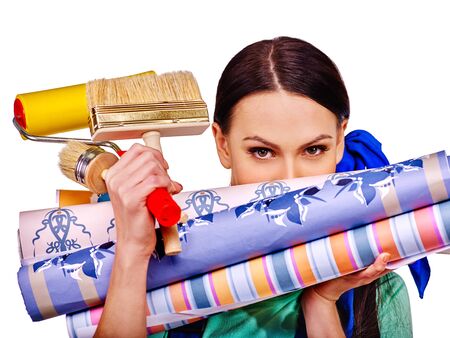 Builder woman  looks out for wallpaper roll.の写真素材