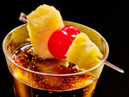 Champagne  cocktail with cherry and yellow pineapple in highball glass . Top view.の写真素材