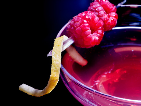 Close op of raspberries drink on black background.の写真素材