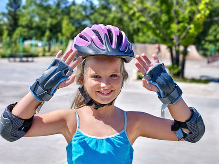 Portrait of girl in sport helmet riding on roller skates in skatepark.の写真素材