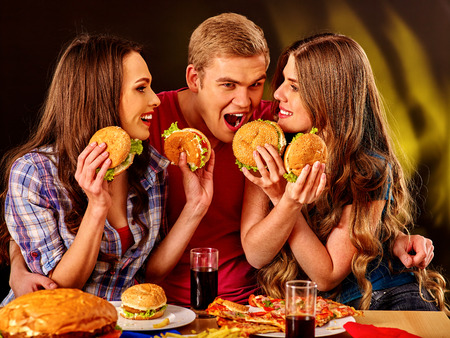 Small group people holding hamburgers and drinks cola .の写真素材