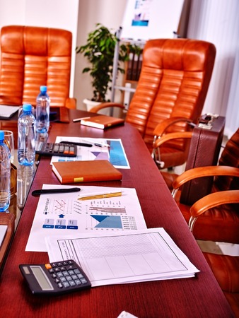 Business interior with four leather chairs in office. There are bottles water on the table.の写真素材