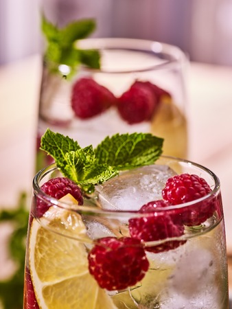 Part of two alcohol cocktail glasses with berries lemon and ice cubes. Alcohol country cocktail...