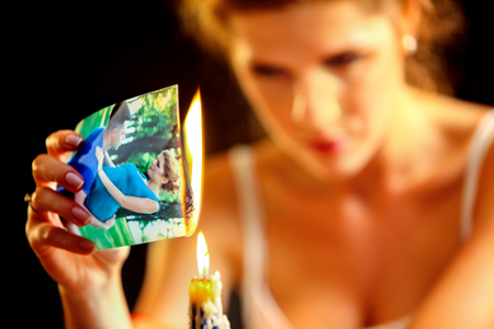 Uhappy girl burn love photos. Love is gone. Model on photo is the same image in the picture.の写真素材