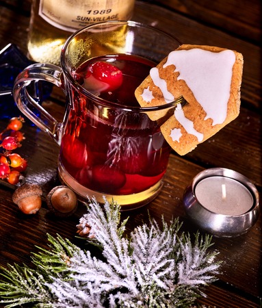 Still life of winter hot drink mulled and spruce branch. Warming mulled wine with cookie in form of house. Top view.の写真素材