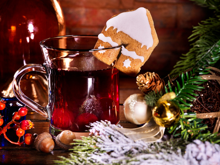 Winter hot drink. Warming mulled wine with cookie in form of house.の写真素材