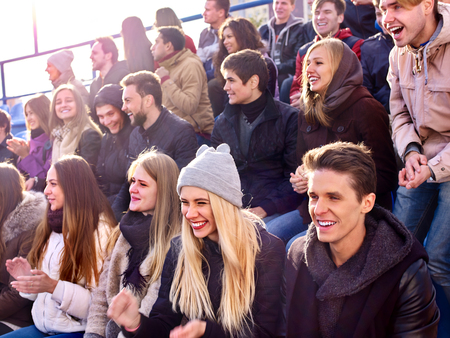 Sport fans clapping and shout on tribunes. Group people. Sport fans enjoyed winter sports.の写真素材