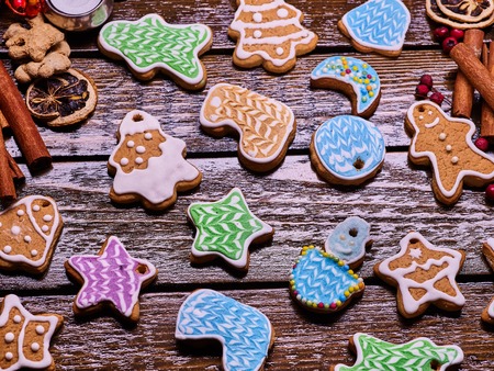 Christmas background gingerbread cookies and cinnamon sticks on woden table .の写真素材