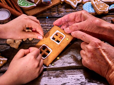 The family made a gingerbread house for Christmas. Christmas with his family at home.
