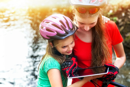 Bicyclist girl watch on tablet computer.の写真素材