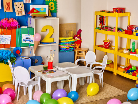 School interior with paint and crayon. No people in kindergarten or preschool. Classroom Interior with chairs, table and toys.の写真素材