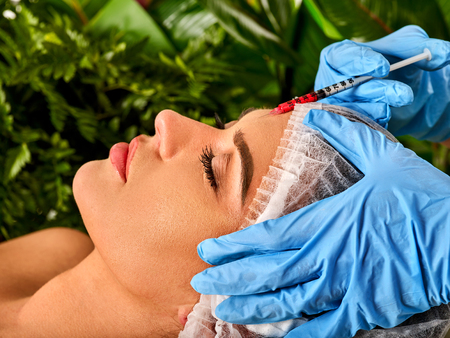 Filler injection for female forehead face. Plastic aesthetic facial surgery in beauty clinic. Botox...
