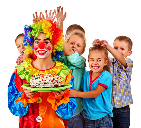Clown keep cake on birthday with group children. Clown and children posing at camera. Isolated.の写真素材