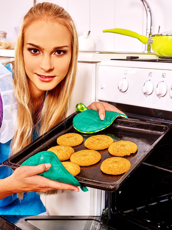 Young woman bake a lot of cookies. Kitchen.の写真素材
