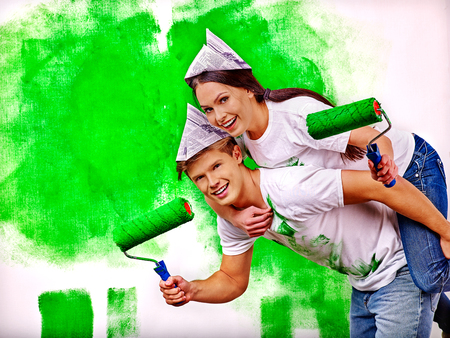 Happy young family paint wall at home.の写真素材