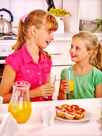 Happy children   breakfast and speaking at kitchen.の写真素材