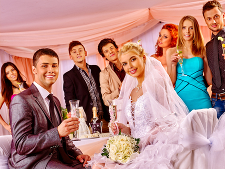 Happy wedding couple drinking champagne.の写真素材