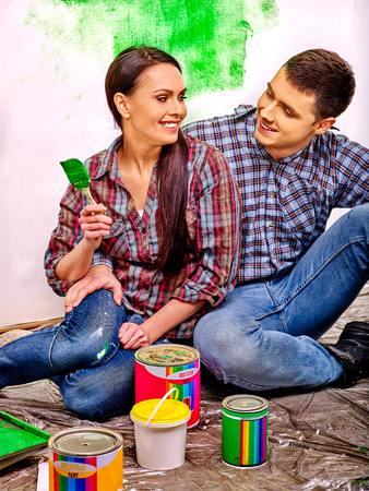 Happy family painting wall in green  at home.の写真素材