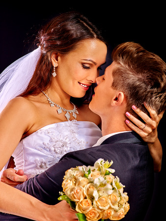Groom kissing beautiful bride on happy wedding.の写真素材
