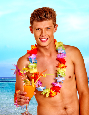 Man with cocktail at Hawaii wreath beach. Summer outdoor.の写真素材