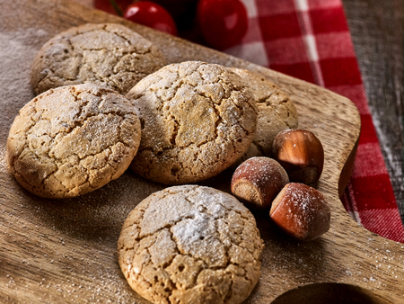 Oatmeal cookies and nut cookies with crack pattern on cutting board on table in rustic style. New recipes.の写真素材