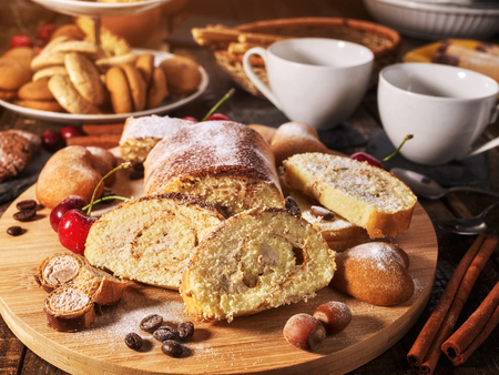 Sand nut chocolate cookies and rolled biscuit on board and cinnamon stick and straw pastry on kitchen on wood table in rustic style top view. Optimal level of glucose in blood.の写真素材