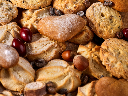 Oatmeal Cookies and sand chocolate cake with nut on wooden table in farm style close up. Perfect for breakfast.の写真素材