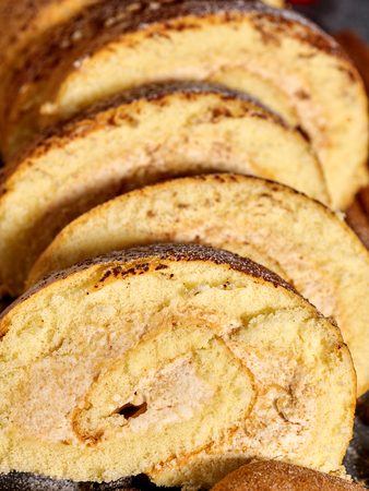 Slice rolled biscuit cake with cream for breakfast dessert close up.の写真素材