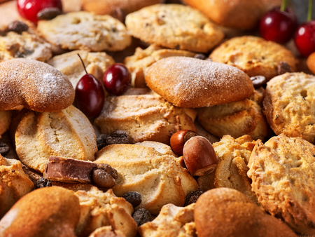 Oatmeal Cookies and sand chocolate cake with nut on wooden table in farm style close up. Perfect product.の写真素材