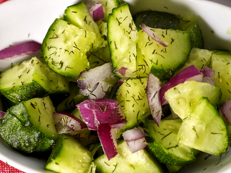Cucumber salad with onion and herbal healthy food on plate.の写真素材