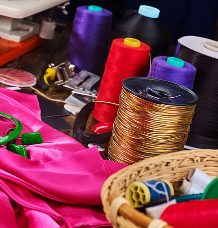 Seamstress group object gold cord sewing spool with embroidery hoop and needlework basket.の写真素材