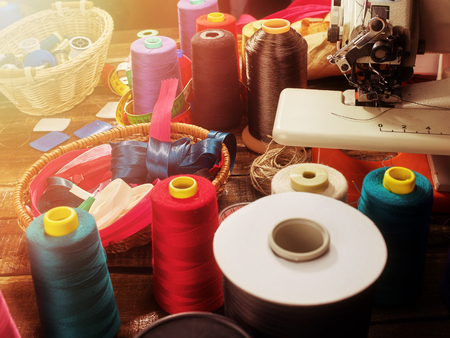 Serger or overlock thread in seamstress with group sew object sewing spool on morning sunrise light sun flare.の写真素材