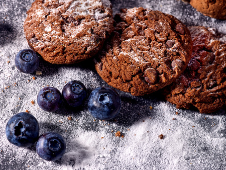 Serving food on slate onto wooden table. Oatmeal cookies biscuit with blueberry on picnic. Chocolate Xmas holiday chip cookies tied with string. Perfect product. Cooking sweets at home.の写真素材