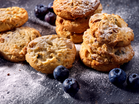 Bakers gonna bake. Serving food on slate. Oatmeal cookies biscuit with blueberry on dark tiles countrylike. Chocolate chip cookies shop on window display. Lunch in inexpensive cafe.の写真素材