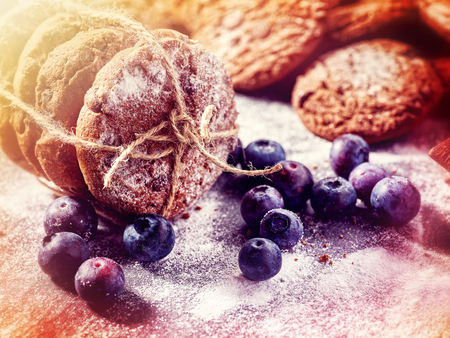 Bakers gonna bake. Serving food on slate . Oatmeal cookies biscuit with blueberry on dark tiles countrylike. Chocolate chip cookies tied with string shop on window display with sunlight on background.の写真素材
